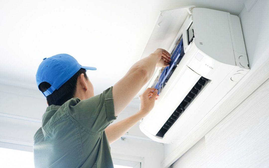 HVAC technician servicing a ductless mini split in Pomona