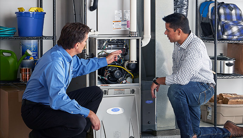 Technician evaluating a furnace for repair or replacement in Pomona