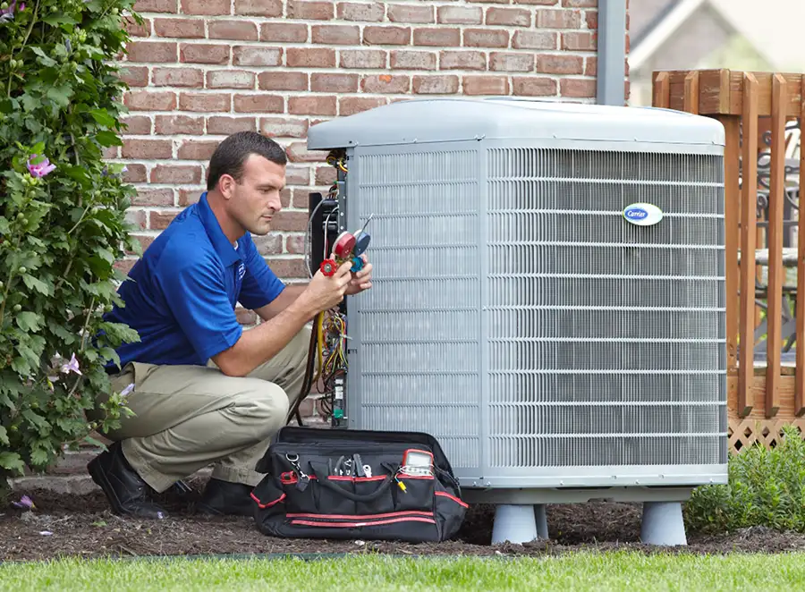 HVAC technician inspecting an outdoor AC unit in Pomona