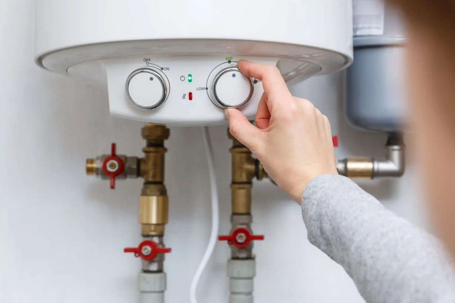Technician adjusting a water heater in Pomona